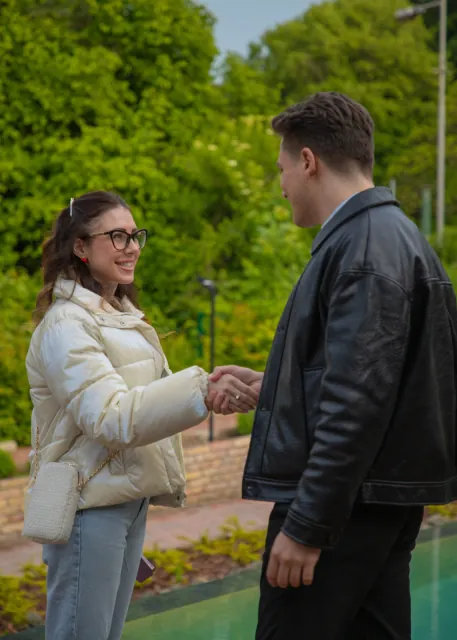 Two guests shaking hands in a garden