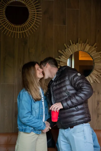 A couple kissing in the lounge