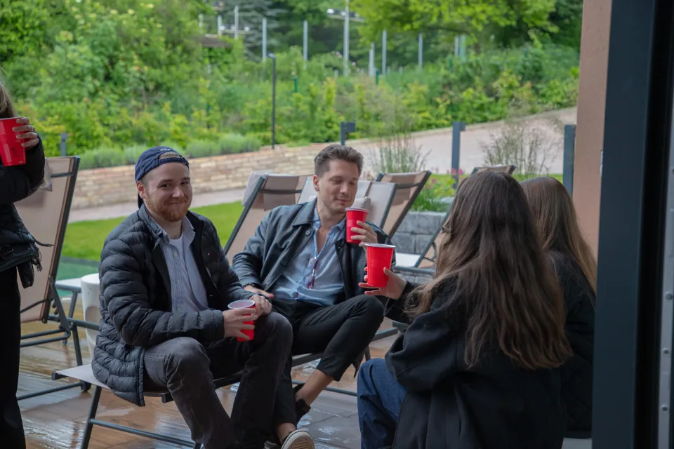 Guests talking over drinks on a garden terrace